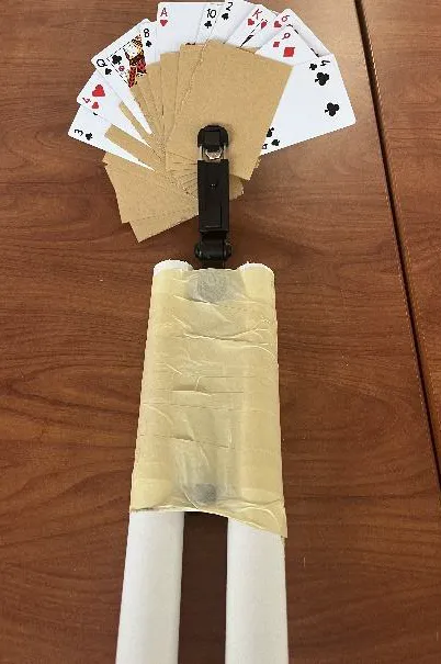 Top view of the prototype opened into a fan with playing cards inserted